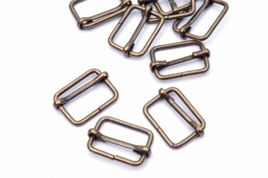 Posunovač kovový vnitřní průvlek 20mm staromosaz